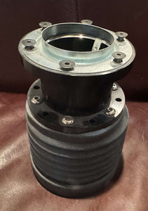 Steering Wheel Extender Hubs displayed on leather surface.