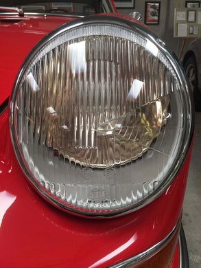 Close-up view of AC Gold Plus LED Headlights with fluted lens on a red vehicle.