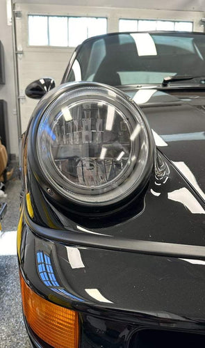Close-up of AC Excellence Series LED headlights installed on an air-cooled Porsche.