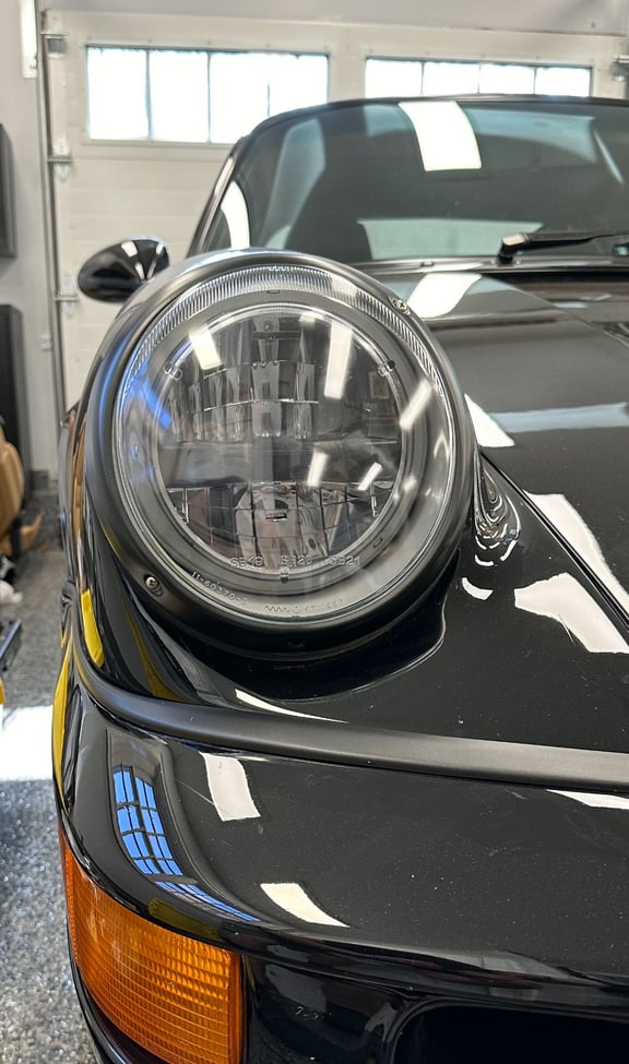 LED headlight on a classic black Porsche, showcasing the AC Platinum™ LED Series.